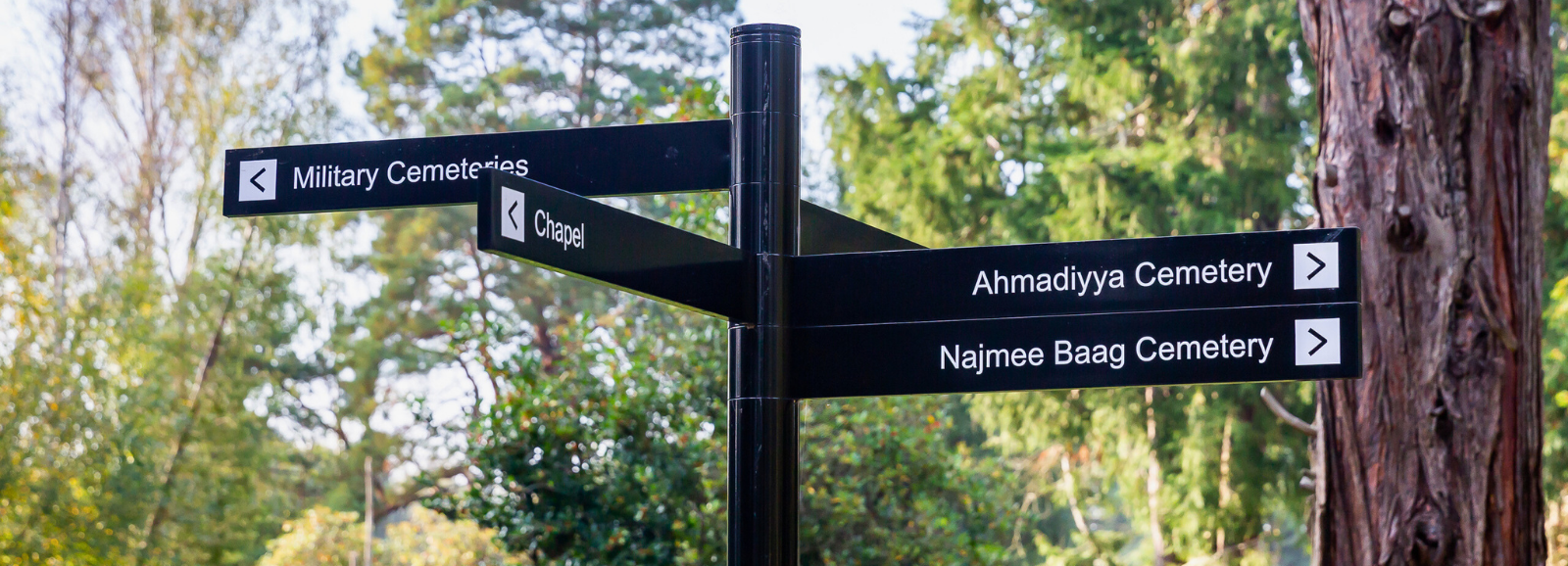 A wayfinding post in the North cemetery directing people to the chapel and other cemeteries.