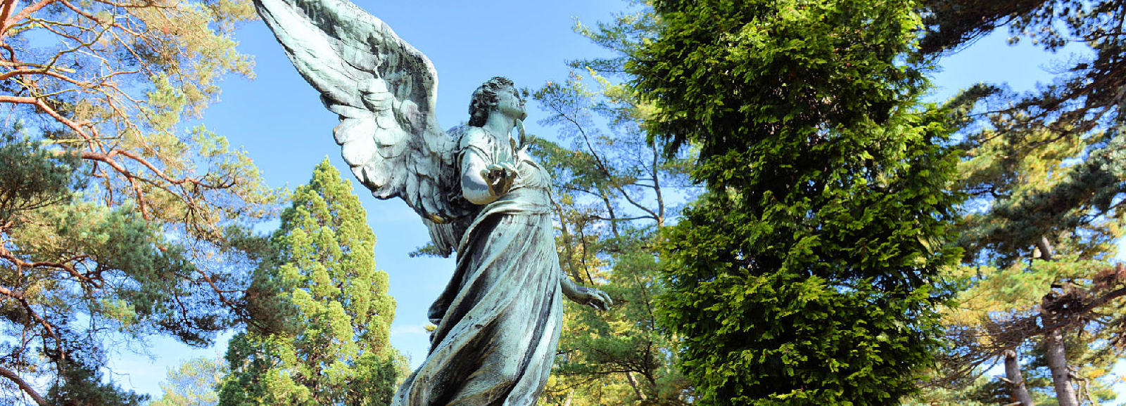 Moir monument comprising a draped figure of peace, holding an olive branch.