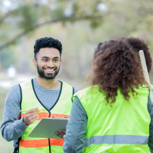 Three corporate volunteers talking to each other.