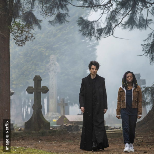 Two characters walking through the cemetery