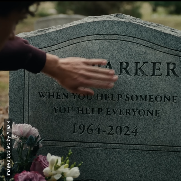 Peter Parker rests a hand on May Parker's grave